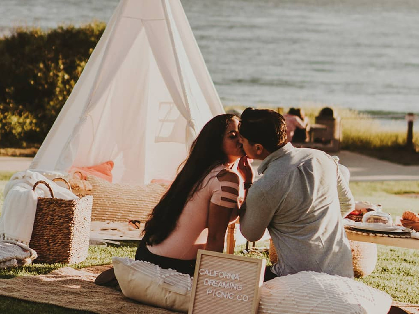 boy and girl at a picnic kissing
