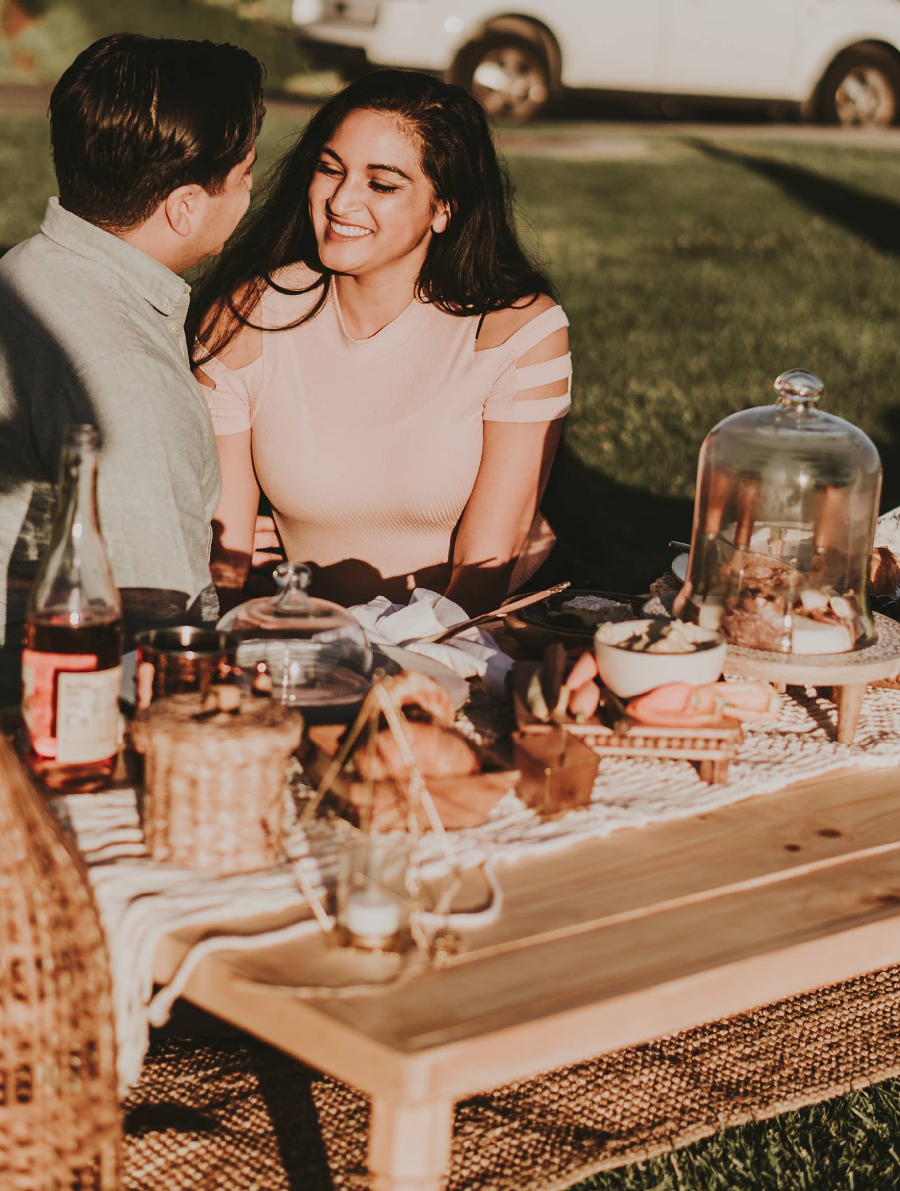 guy and girl smiling at a picnic