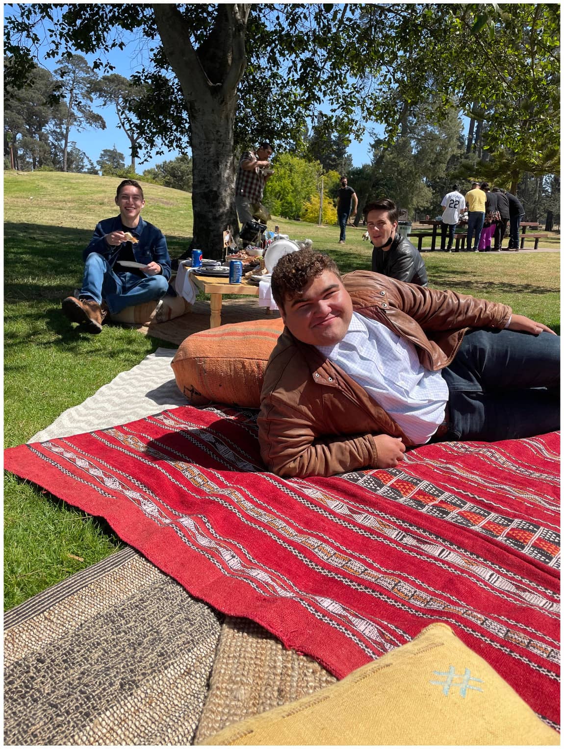 man laying on a rug outside